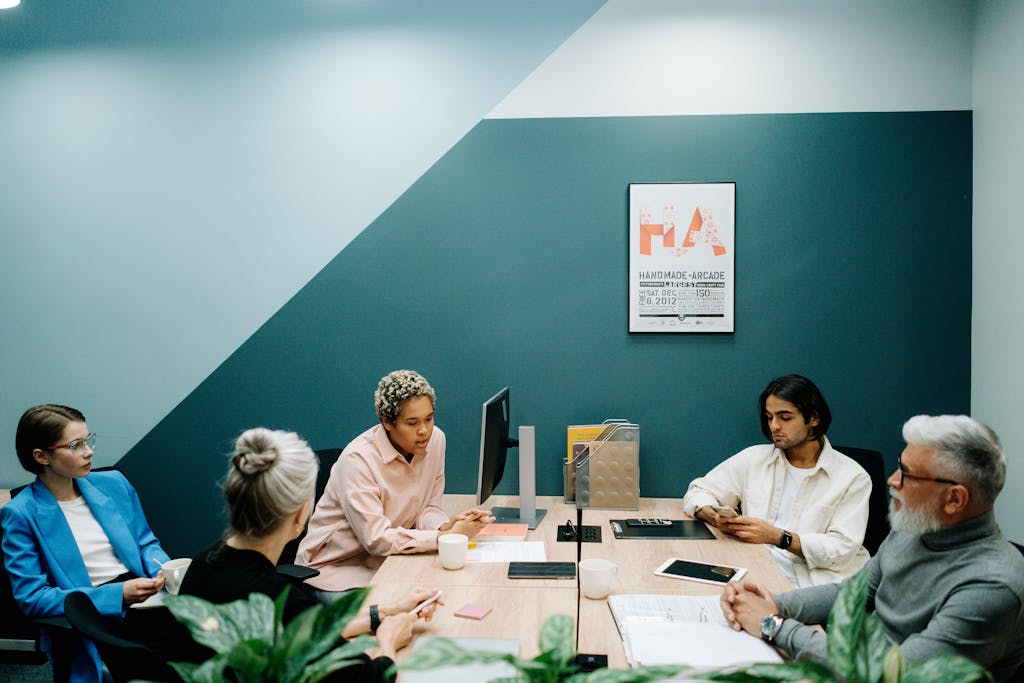 People Sitting Around Table Inside Room