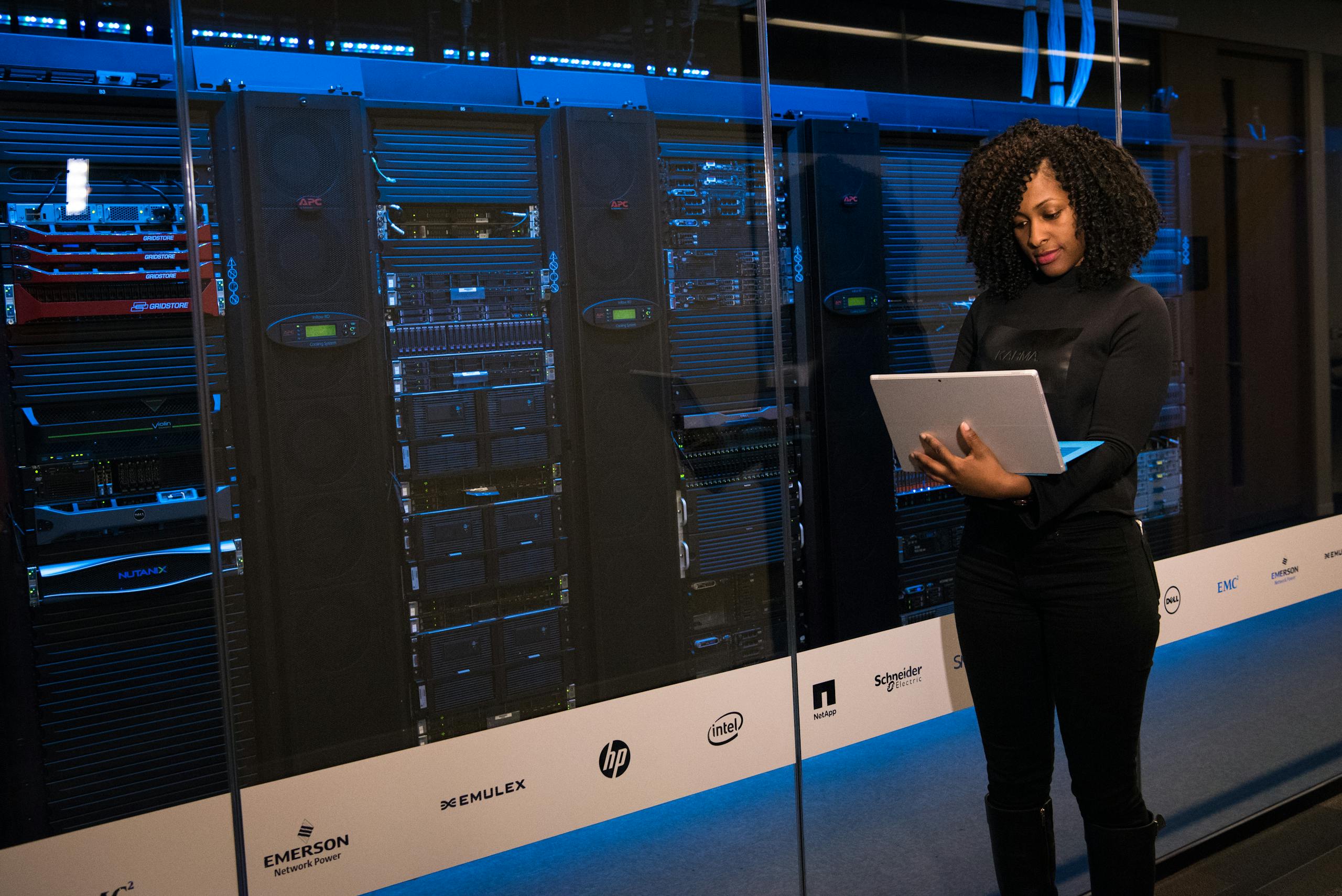 Software Engineer Standing Beside Server Racks for data science interpretation