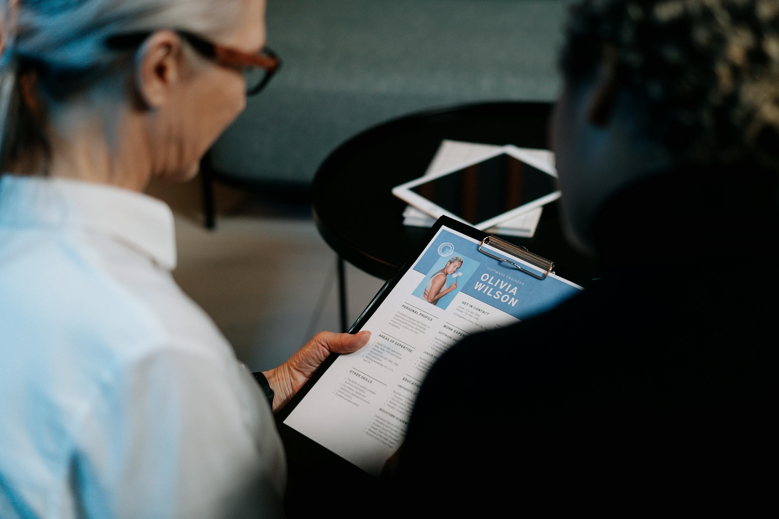 head hunter Woman Holding a Clipboard with Resume